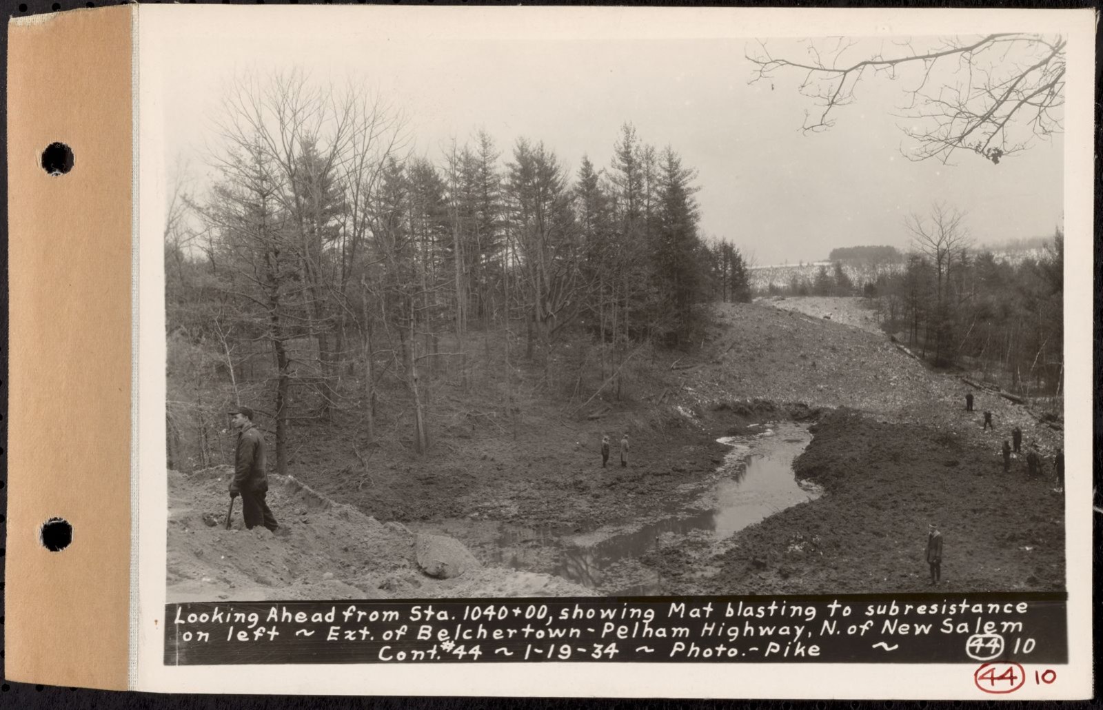 Contract No. 44, Extension of Belchertown-Pelham Highway, New Salem, Orange, looking ahead from Sta. 1040+00, showing mat blasting to subresistance on left, New Salem, Mass., Jan. 19, 1934, Massachusetts Archives - undated