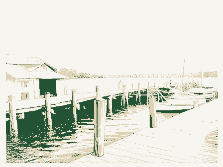 Decorative drawing: a working wharf with pilings, sheds and moored boats. Not a photograph of this place.