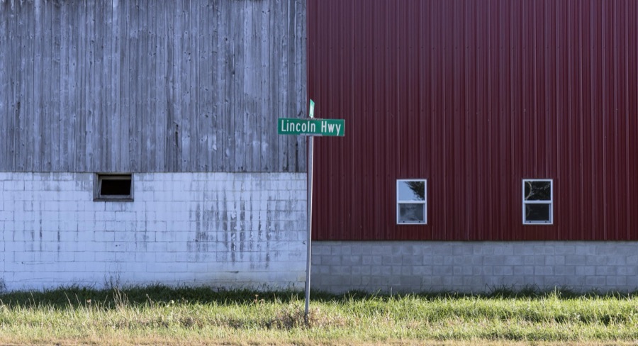 A road sign designating the old Lincoln Highway next to a barn outside Bucyrus, a small city in central Ohio that lies along the historic, originally two-lane, roadway that was the first U.S. highway, numbered U.S. 30 in much of its route, to cross the entire United States in the 1930s
