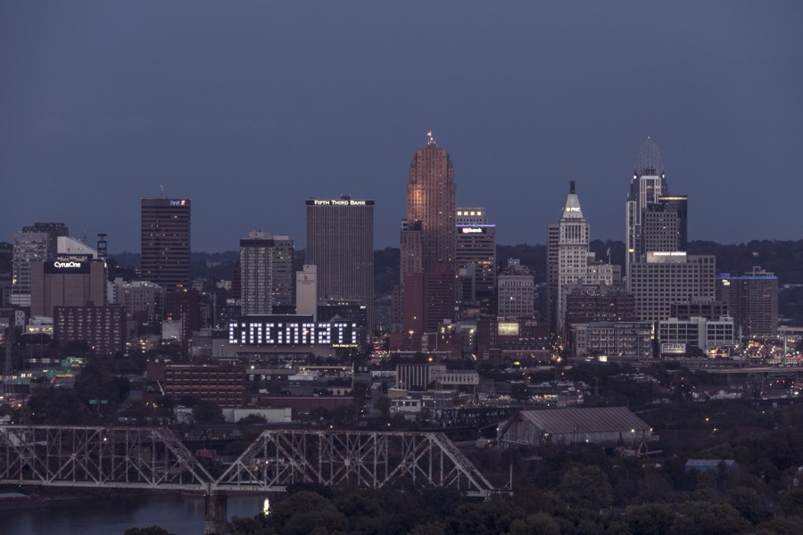 Dusk view of the Cincinnati, Ohio, skyline, including a look at the giant, illuminated "CINCINNATI" sign on the city's convention center, Duke Energy Center