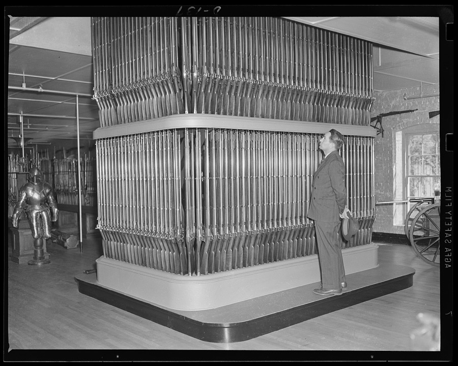 Organ of death. "This is the arsenal. From floor to ceiling, like a huge organ, rise the burnished arms." So wrote Longfellow in his poem, after seeing this stack of 1862 rifles. Now in another emergency the eastern armory again turns out guns for the war