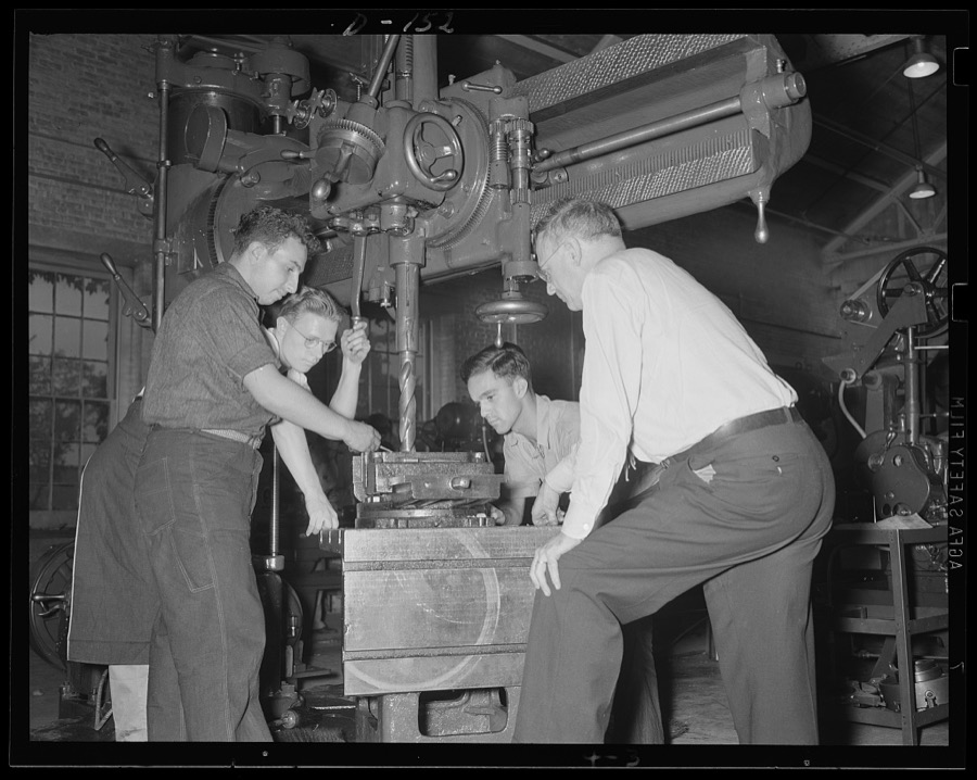 Mass attack. Problems of production for war work are studied by apprentices in an eastern arsenal. Instructors explain the operation of a radical drill
