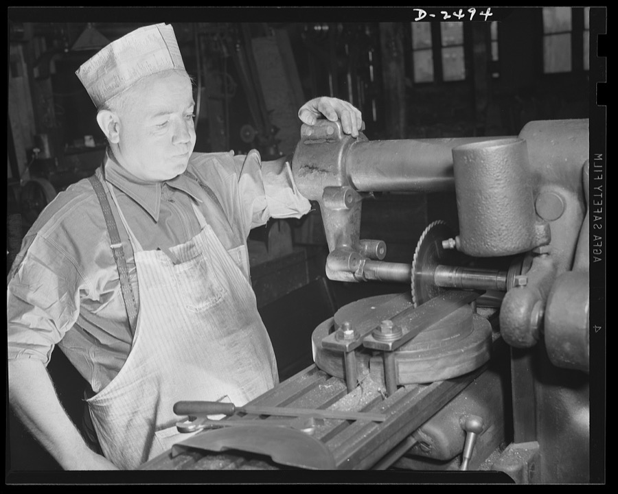 Conversion. Food machinery plant. Operator of this universal milling machine is John J. Morris shown here cutting steel disc covers for his company's normal product--cube steak machines. Today, Morris used the same machine adapted to war subcontract work- -the cutting of large hexagonal nuts for a government arsenal. "Hexing a nut" is a very simple job with a machine designed to shape the entire piece in one operation, but such a machine is not available and time is short. Morris, therefore, shifts the round piece of steel stock three times, cutting two sides in each operation. Cube Steak Machine Company, Boston, Massachusetts
