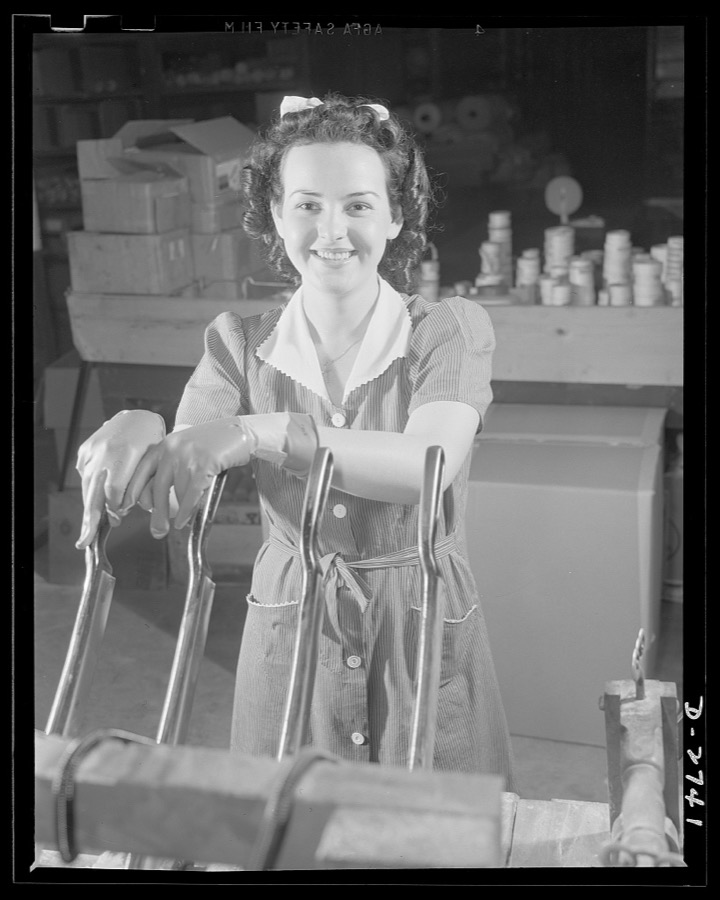 Fiberglass manufacture, Owens-Corning, Toledo, Ohio. Pretty worker in a paint shop of the Owens-Corning Fiberglass Corporation is cutting wafer-thin bonded mats of glass fiber for use as retainer mats in storage batteries supplied under Army and Navy specifications for storage batteries in submarines, tanks, and rough-riding reconnaisance cars