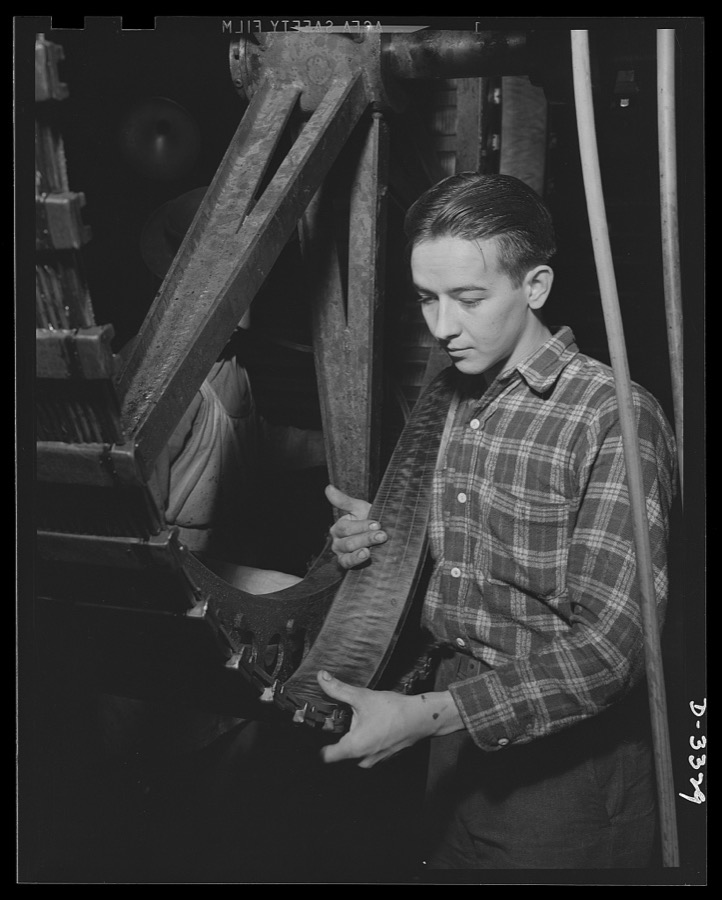 Tracks for scout cars and other Army vehicles grow under the hands of skilled workers of a large Midwest tire plant. Goodrich, Akron, Ohio