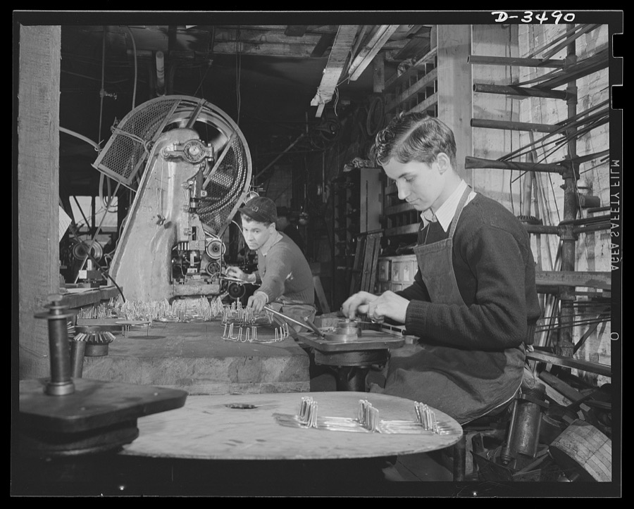 Conversion. Toy furniture to dies for incendiary bombs. This small Midwest machine shop used to manufacture doll's furniture and fly swatters before Pearl Harbor. Subcontracts on defense orders now occupy all machines as rapidly as the old stock can be assembled. Here two high school boys complete machine work on metal legs for the furniture. Sivon Machine Company, Painesville, Ohio