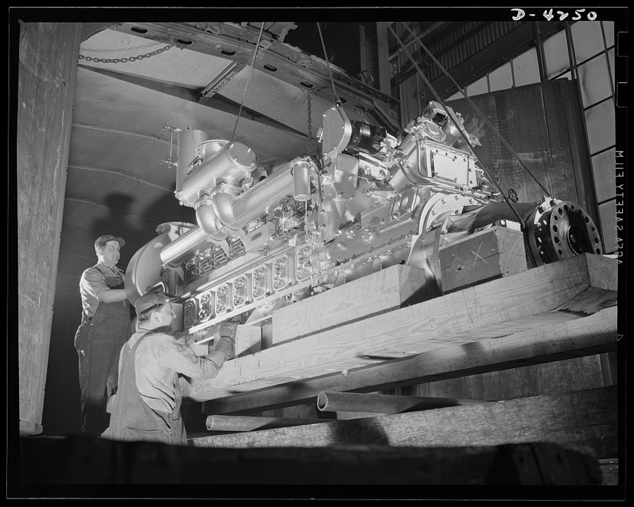 Production. Diesel engines. More power for the Navy. A diesel engine is loaded into a railroad car for shipment from a Midwest manufacturing plant