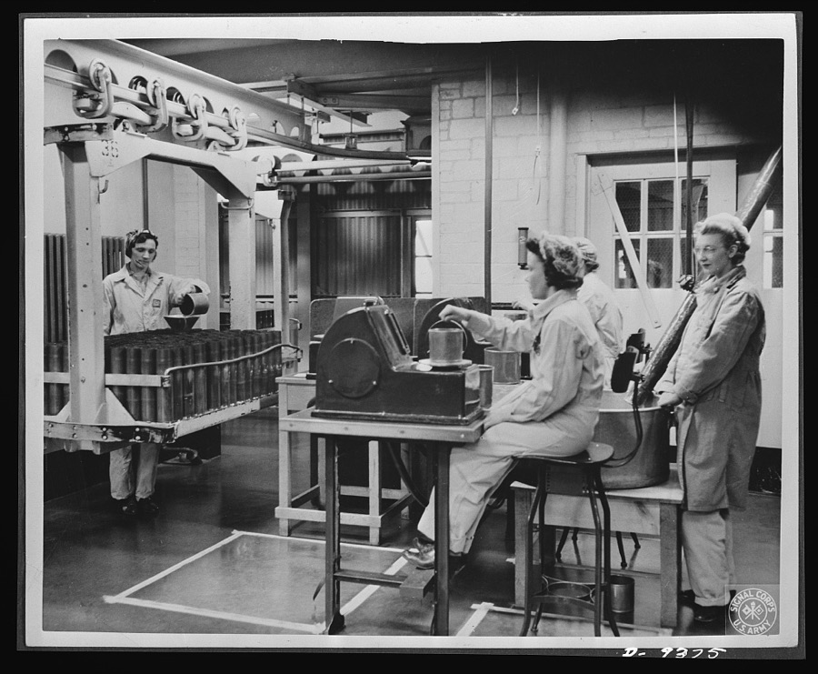 Production. Shell loading. Weighing the propelling charges of smokeless powder before they are poured into shells at a large Midwest loading plant. This precise work is done mostly by women. Mechanical devices produced in the fuse division enable soldiers in the field to delay or accelerate the explosion of a projectile. Ravenna ordnance plant