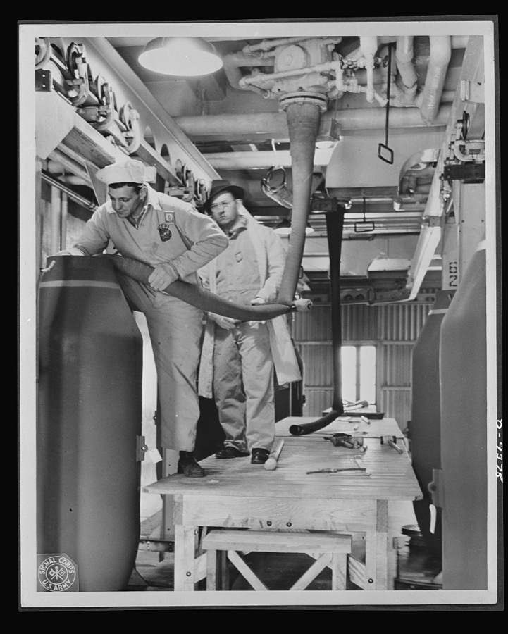 Production. Shell loading. Nonchalantly loading a two-ton "block buster" at a large Midwest plant. Every precaution is taken, but a certain stoicism is required for this job. The workmen fill each end of the bomb with TNT, delivered "hot," and the remaining spaces with amatol, a mixture of fifty percent ammonium hydrate and fifty percent TNT. Ravenna ordnance plant