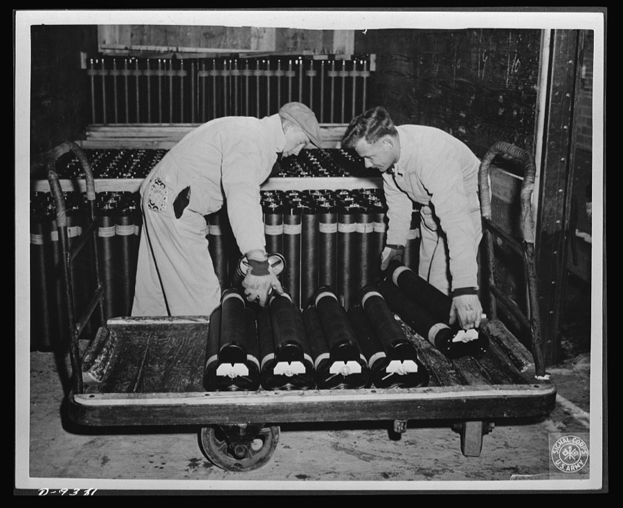 "Cloverleaf clusters" is the official title for these packages of 105 mm. artillery shells. Delivery lines are speedy at the large Midwest loading plant where they are made. Fourteen 2,000-pound bombs have been removed from a truck and placed in a freight car in fourteen minutes--and four 4,000-pound "block busters" have been moved from truck to freight car in fifteen minutes. Ravenna ordnance plant