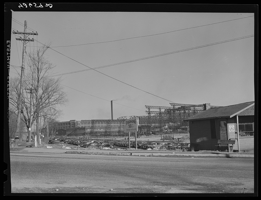 A large parking lot with the shipyards in the background. Quincy, Massachusetts