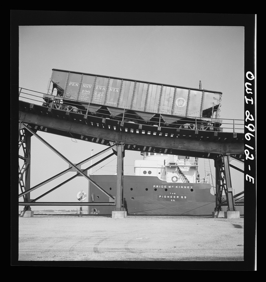 Sandusky, Ohio. Loading coal into a lake freighter at the Pennsylvania Railroad docks. The car that has just been emptied is going down the kick-back trestle